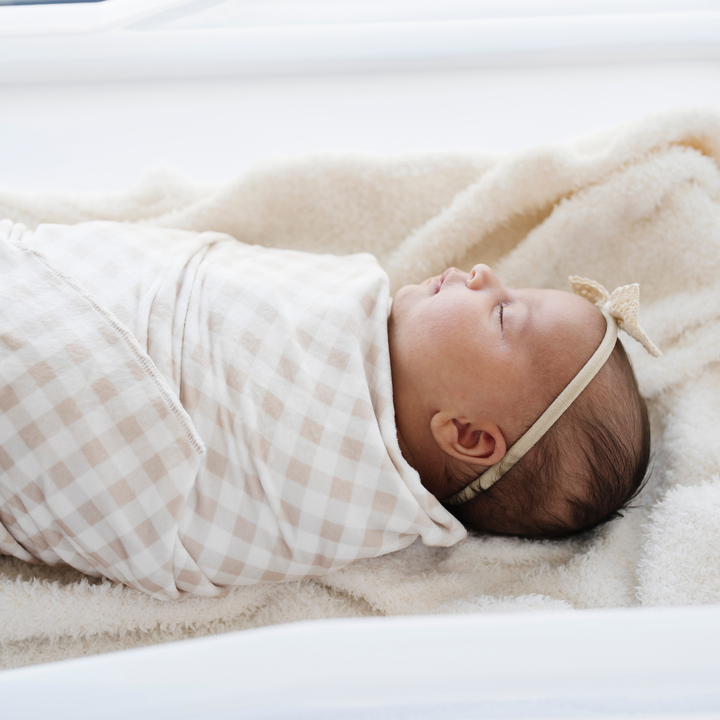 The Saranoni Minky Stretch Luxe Swaddle/Blanket in Gingham is luxe, stretchy, and makes a perfect baby boy blanket pick.