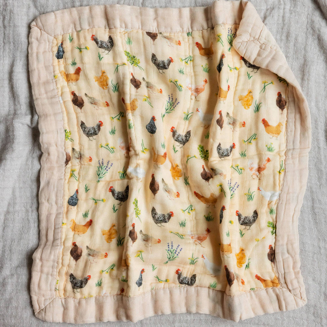 1canoe2 Chicken Meadows muslin baby blanket laid flat, overhead view of the farmhouse chicken print security blanket