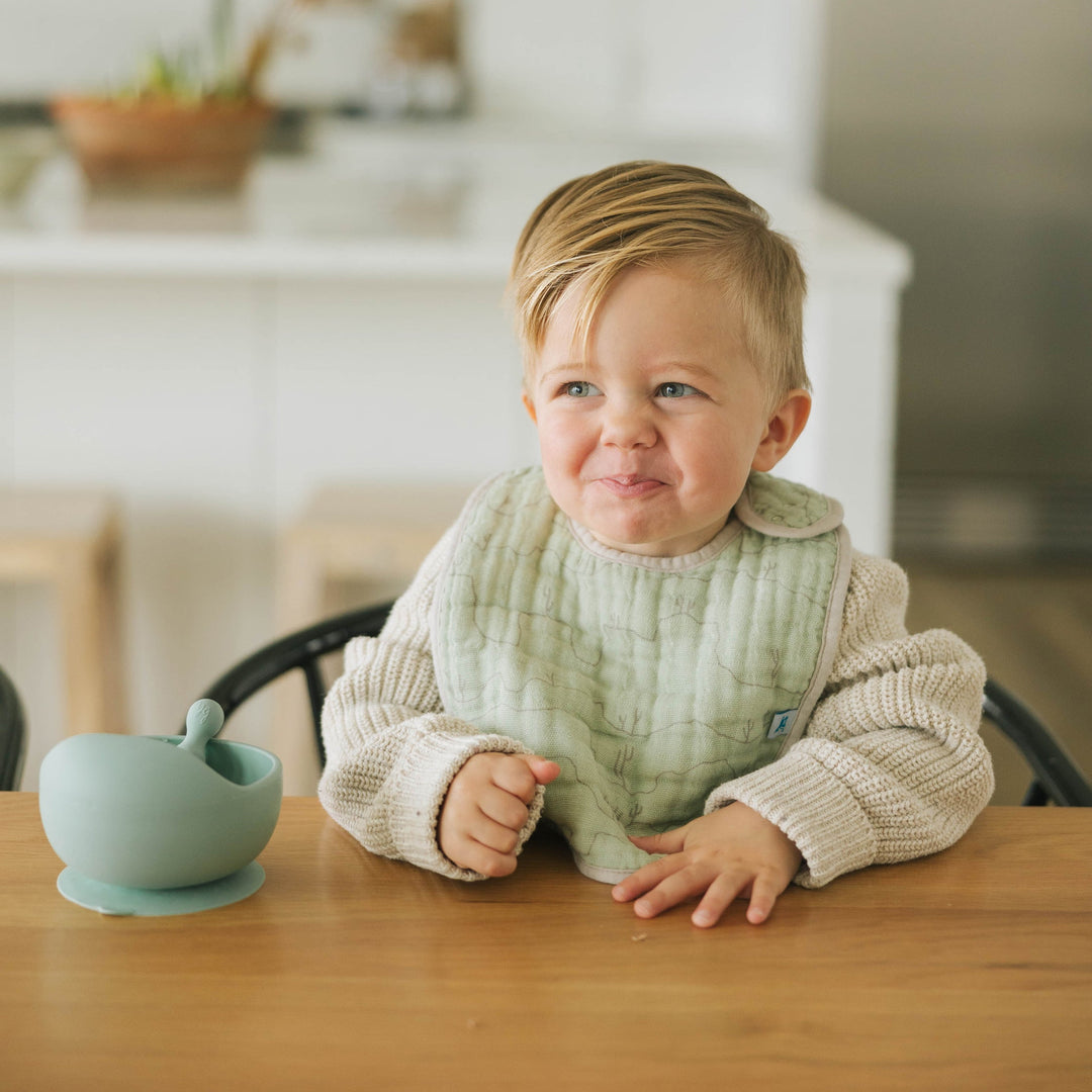 Close-up shot of Little Unicorn Cotton Muslin Classic Bib 3 Pack - Adobe Checker, versatile and cute bibs for baby.
