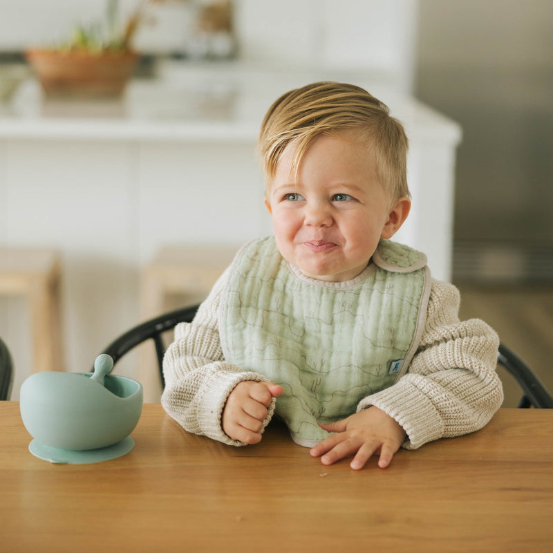 Close-up shot of Little Unicorn Cotton Muslin Classic Bib 3 Pack - Adobe Checker, versatile and cute bibs for baby.