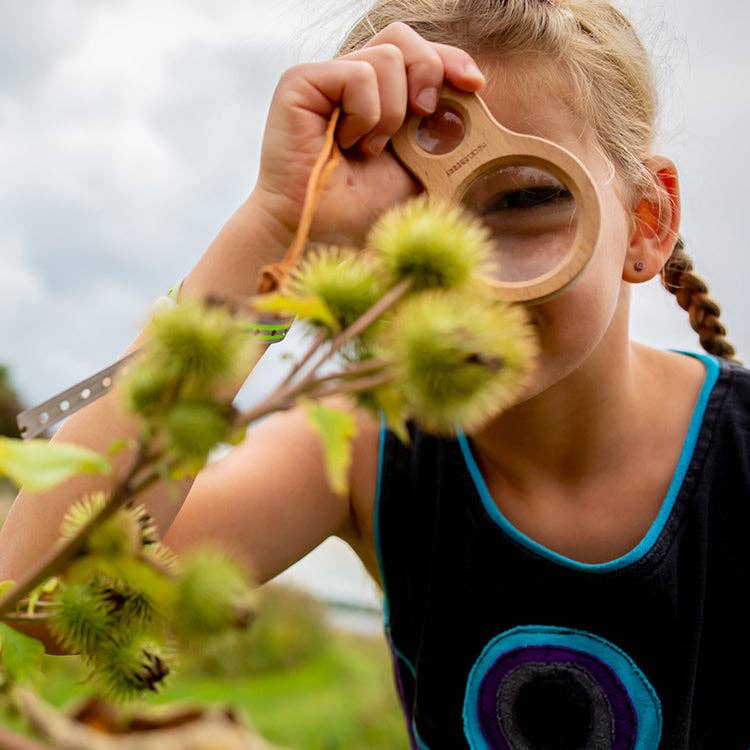 Child using Huckleberry Dual Magnifier to examine nature