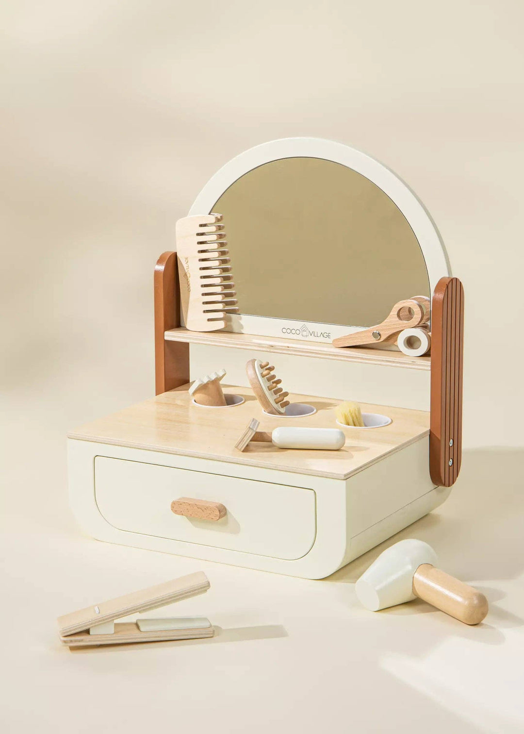 Styled in soft Peach, the Coco Village Wooden Beauty Station Playset is a charming wooden toy that invites open-ended salon play.