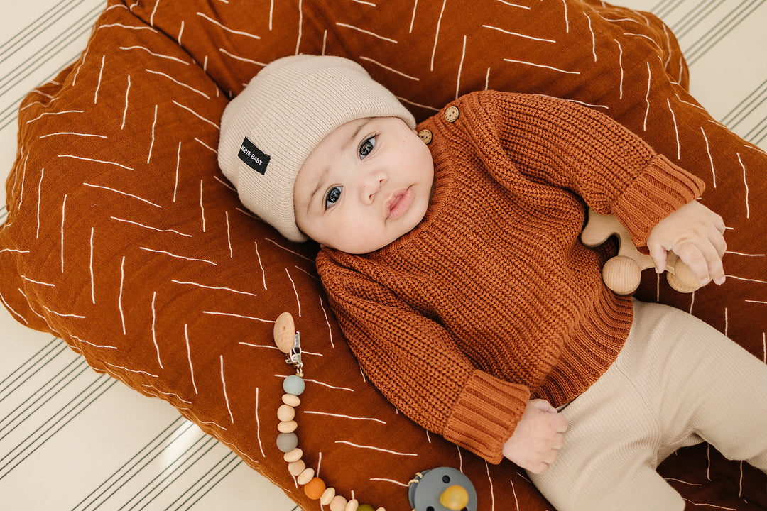 Worn by a crawling baby, the Mebie Baby Oatmeal Organic Leggings.