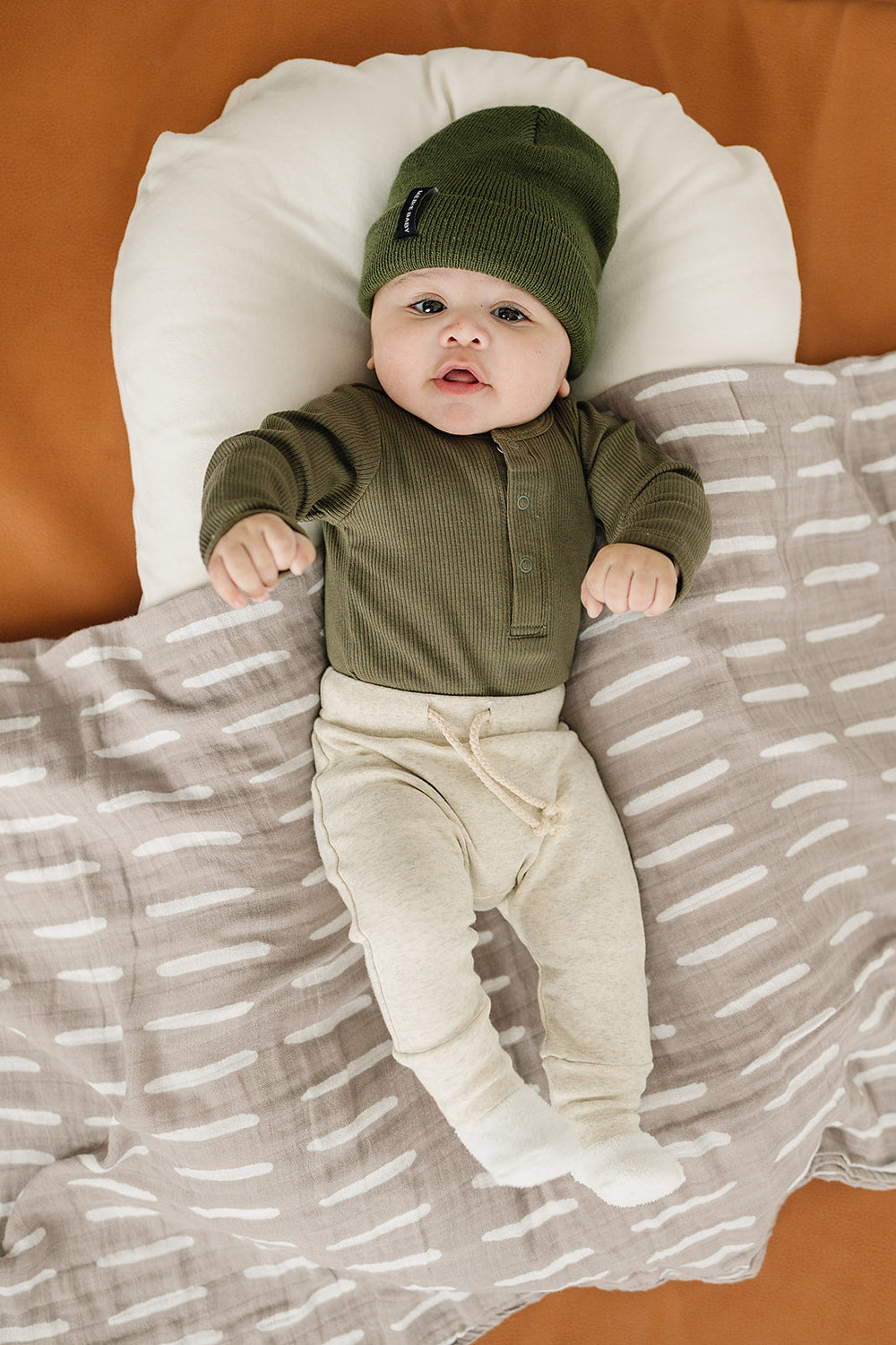 Folded product shot of the Winter Green Organic Snap Long Sleeve Ribbed Bodysuit highlighting this bamboo snap bodysuit