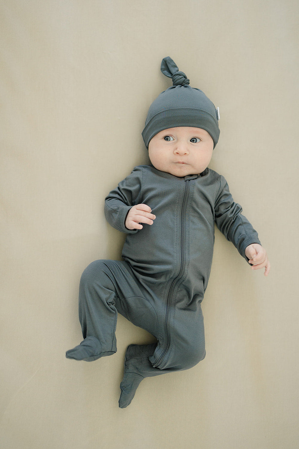 Laid flat to show the ribbed fabric, the Charcoal Bamboo Footed Zipper from Mebie Baby.