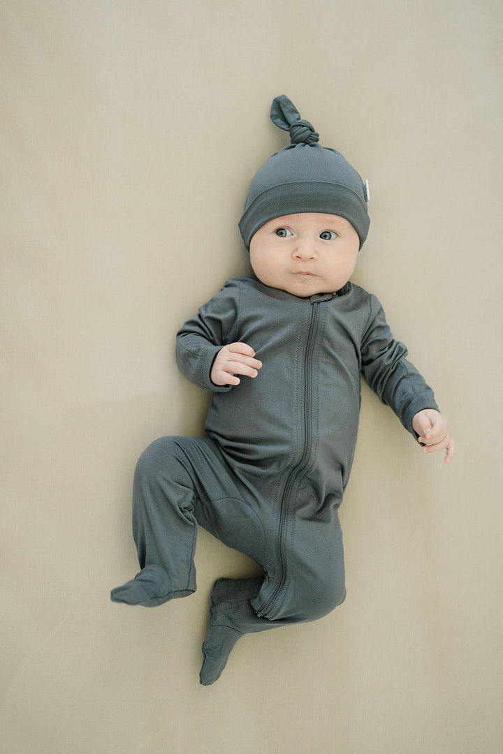 Laid flat to show the ribbed fabric, the Charcoal Bamboo Footed Zipper from Mebie Baby.