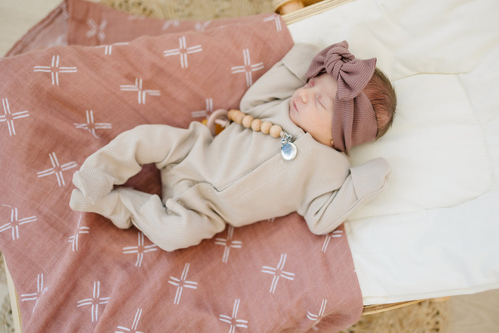 Laid flat to show the ribbed fabric, the Oatmeal Organic Cotton Ribbed Snap from Mebie Baby.