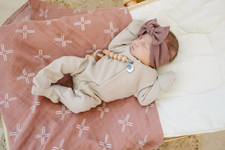 Laid flat to show the ribbed fabric, the Oatmeal Organic Cotton Ribbed Snap from Mebie Baby.