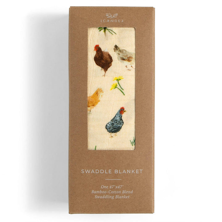 1canoe2 Chicken Meadows baby swaddle in retail packaging, a muslin swaddle blanket ready to gift newborns