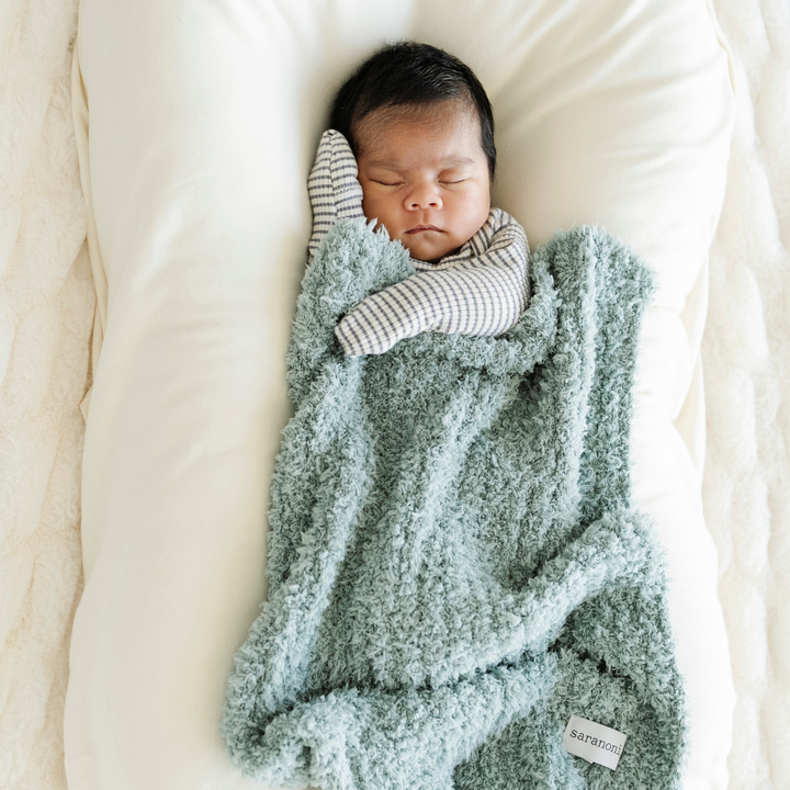 The Saranoni Ribbed BAMBONI¨ Mini Blanket in Surf feels irresistibly smooth, a timeless choice for baby girl blankets.