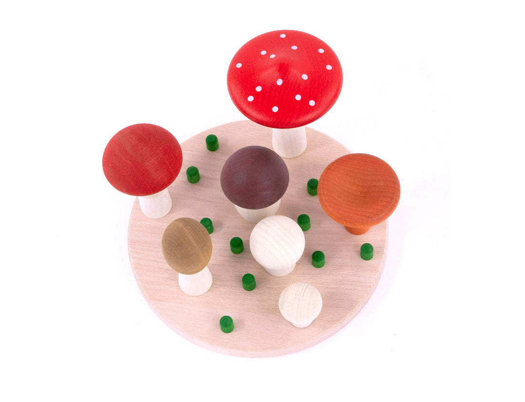 Top view of colorful wooden mushrooms on a peg base, Mushrooms Sorter by Bajo, heirloom stacking toy, woodland nursery gift