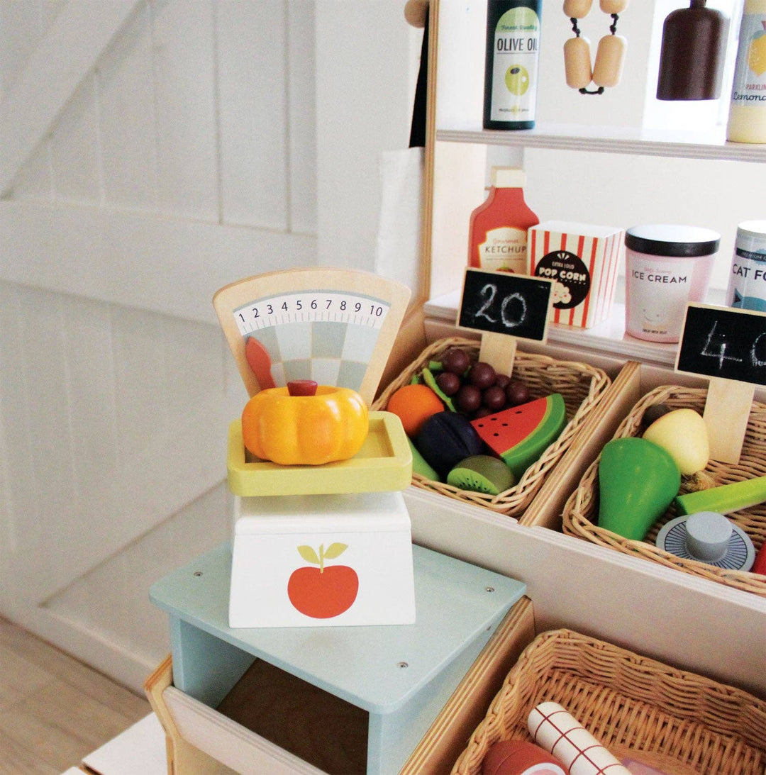 Market Scales set up inside a make believe store scene from Tender Leaf Toys