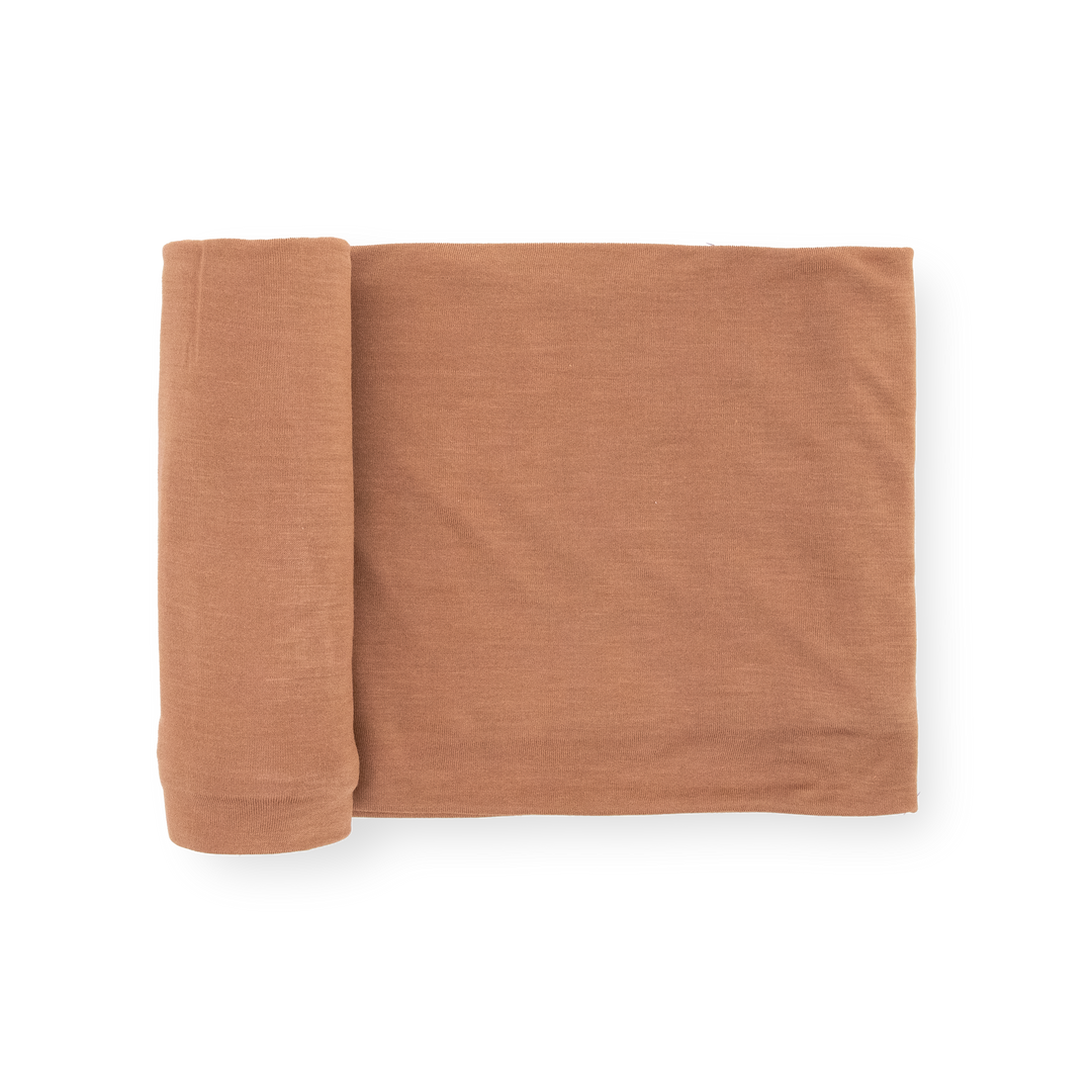 Little Unicorn Stretch Knit Swaddle Blanket in Terracotta, soft baby blanket for newborns.