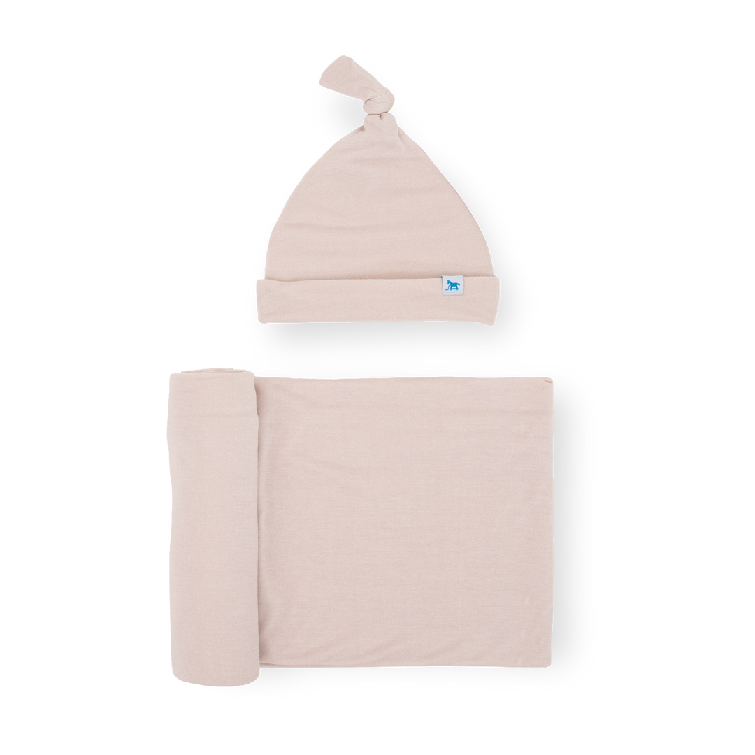 Little Unicorn Stretch Knit Swaddle and Hat Set - Soft Blush folded neatly, soft muslin blankets for newborn comfort