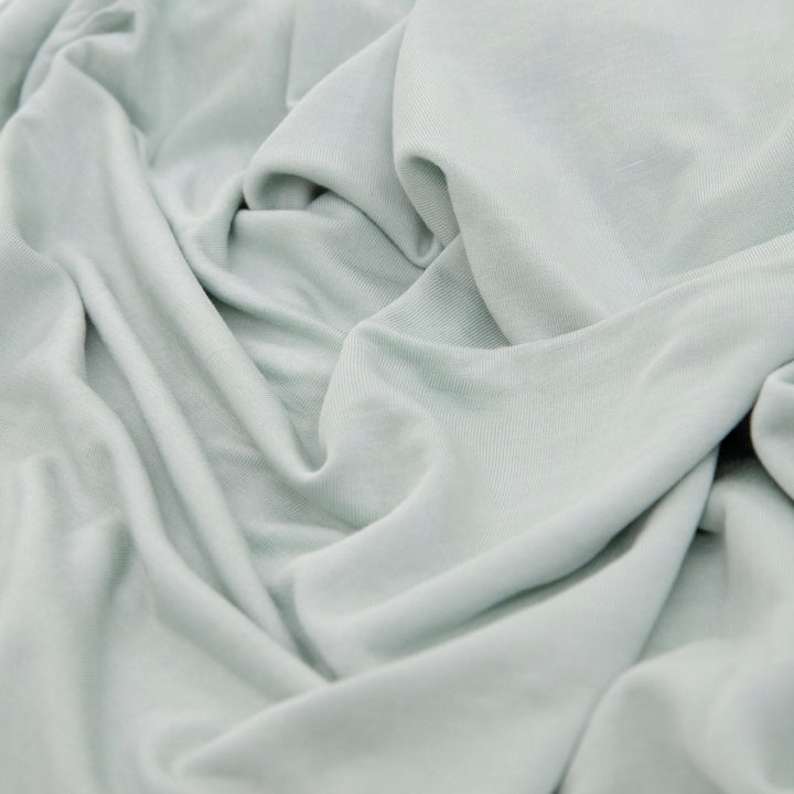Wrap your baby in comfort with Little Unicorn Stretch Knit Swaddle Blanket, Frost Green muslin swaddle.