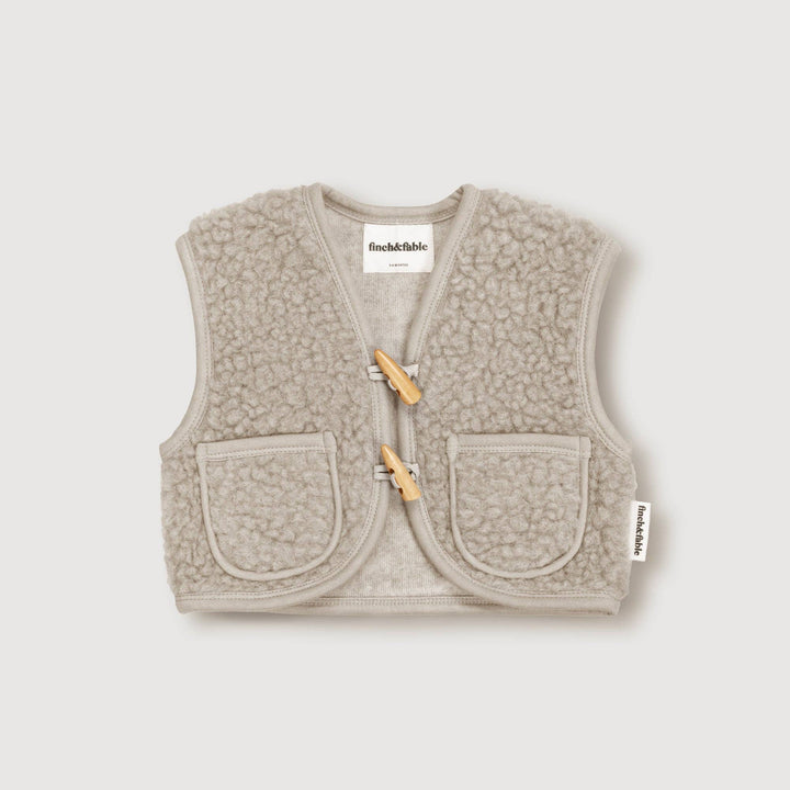 Layered effortlessly, the Finch & Fable Wool Sherpa Vest Ð Sand brings cozy texture to everyday baby clothes