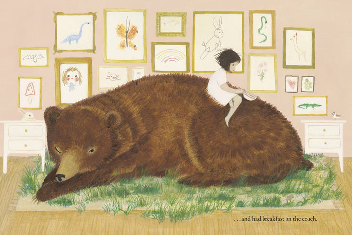 Little girl resting on a sleeping brown bear, The Wildest Thing from Penguin Random House, illustrated storybook gift