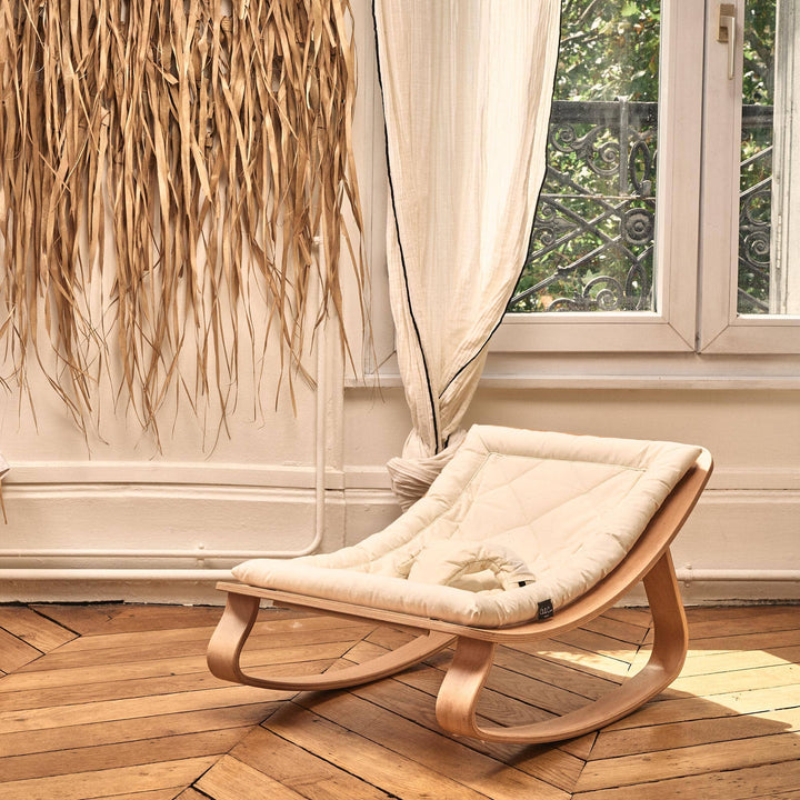 Finished in Organic Milk, the Charlie Crane LEVO Rocker | Beech offers plush comfort in a signature Charlie crane rocker