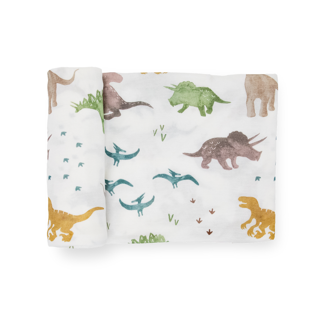Little Unicorn Stretch Knit Swaddle Blanket - Dino Pals folded neatly, soft muslin blankets for newborn comfort