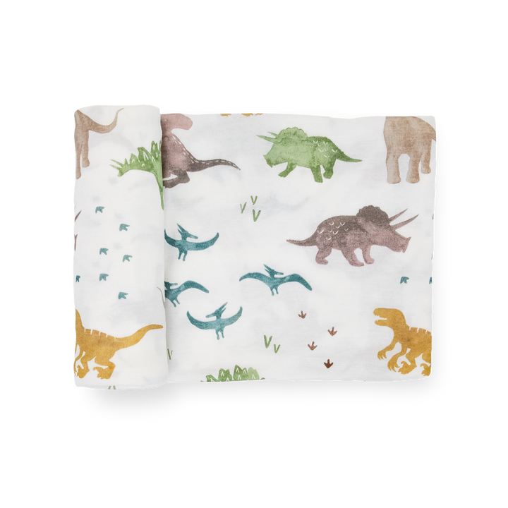 Little Unicorn Stretch Knit Swaddle Blanket - Dino Pals folded neatly, soft muslin blankets for newborn comfort