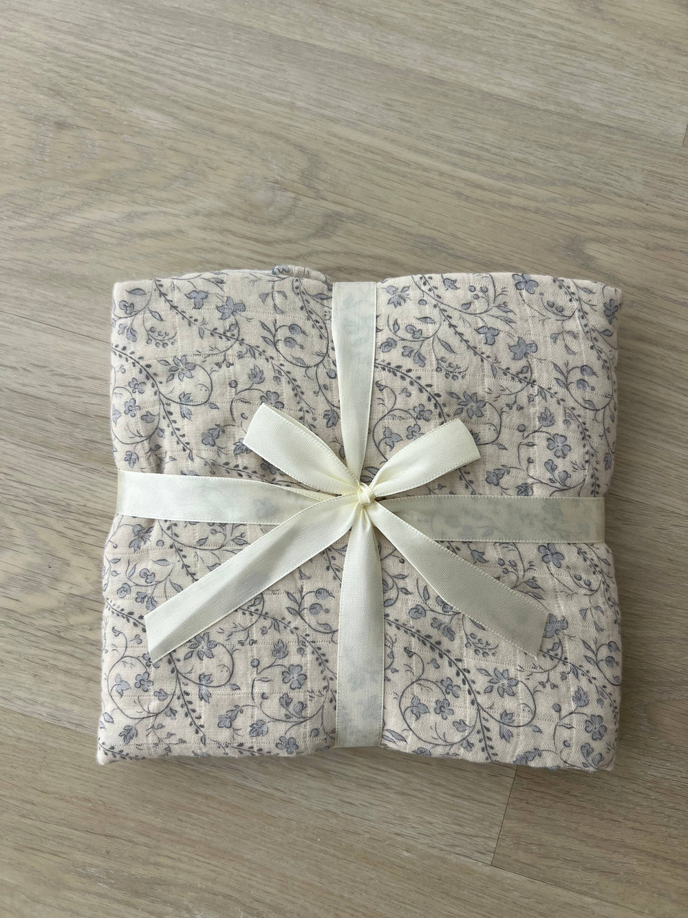 Folded Little Threads bluebell muslin blanket with ribbon, baby shower gift blanket, soft swaddle for newborns, toddlers, and nursery