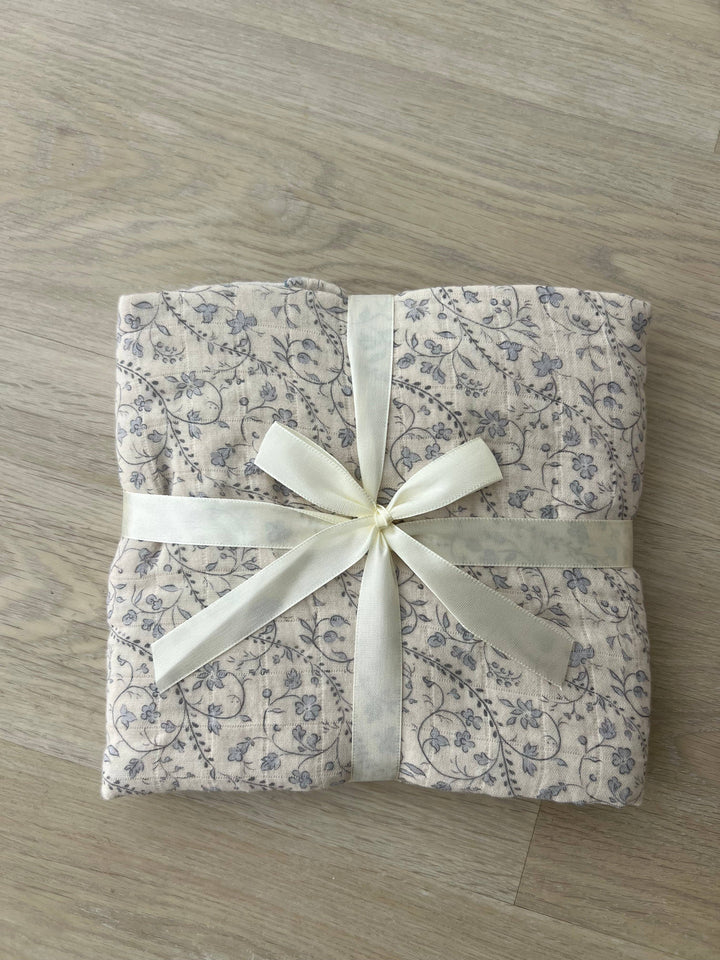 Folded Little Threads bluebell muslin blanket with ribbon, baby shower gift blanket, soft swaddle for newborns, toddlers, and nursery