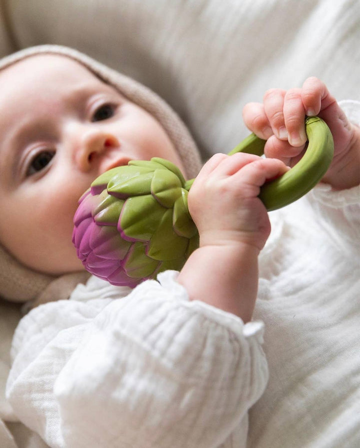 Baby holding Oli and Carol Artichoke infant teether