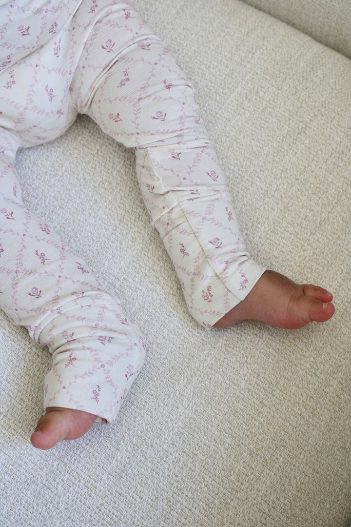 Close up of Little Threads mauve bamboo footie fabric and covered foot, breathable baby pajamas for warmth, comfort, and gentle movement