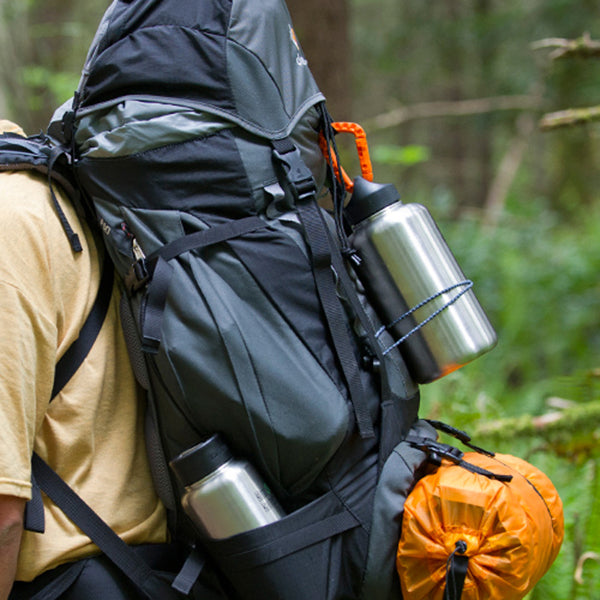 Backpack view of Klean Kanteen 64oz Wide Water Bottle in Black, non toxic and minimalist design for easy outdoor use.