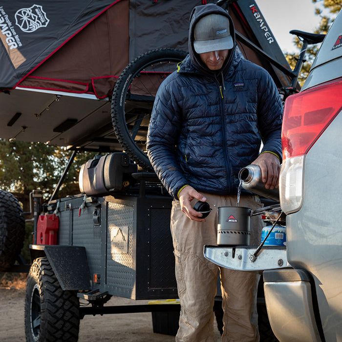 Outdoor camping pour with Klean Kanteen 64oz Wide Water Bottle in Black, recycled stainless steel and backcountry filter compatible.