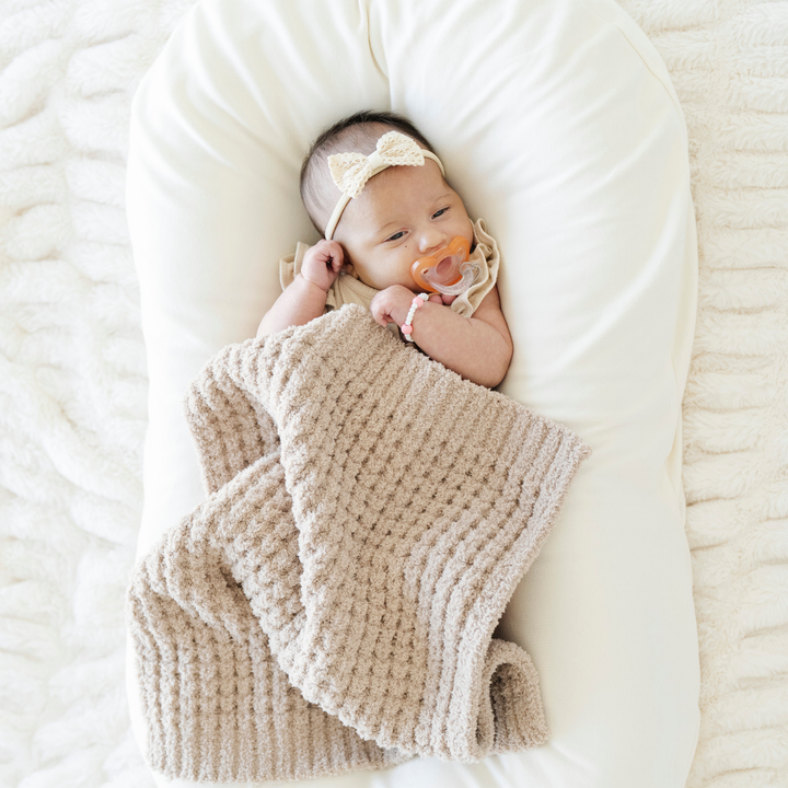 Wheat Saranoni Waffle Knit Mini Blanket makes modern snuggling easier with structured cozy texture as a Knitted baby blanket.