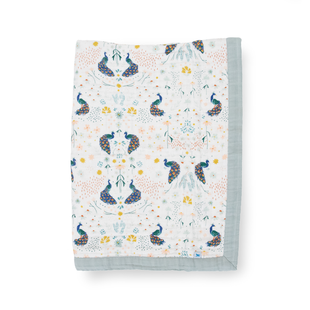 Little Unicorn Cotton Muslin Baby Quilt - Peacock displayed in a bold peacock print, a cozy muslin baby blanket perfect for snuggles.