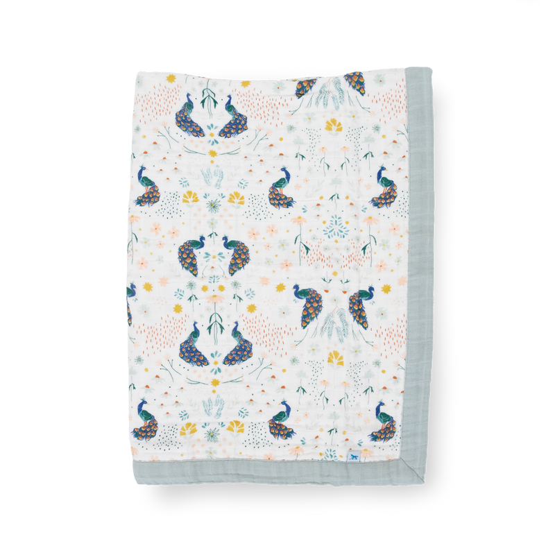 Little Unicorn Cotton Muslin Baby Quilt - Peacock displayed in a bold peacock print, a cozy muslin baby blanket perfect for snuggles.