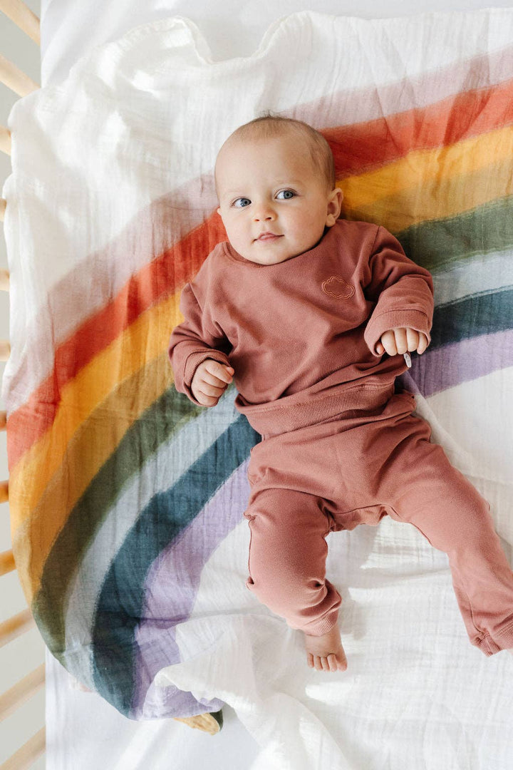The Clementine Kids Rainbow Swaddle crafted in muslin swaddle blankets for little ones.