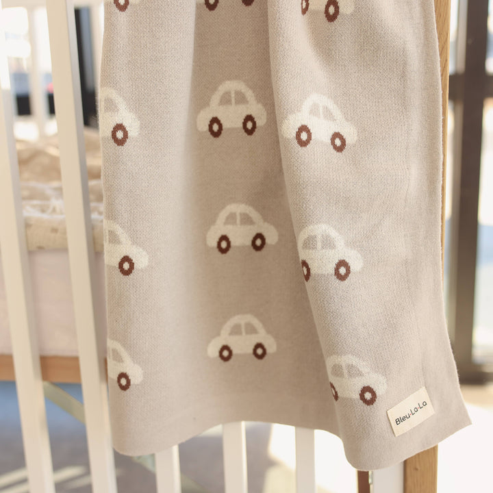 blu la la cars knit cotton newborn blanket hanging from crib 