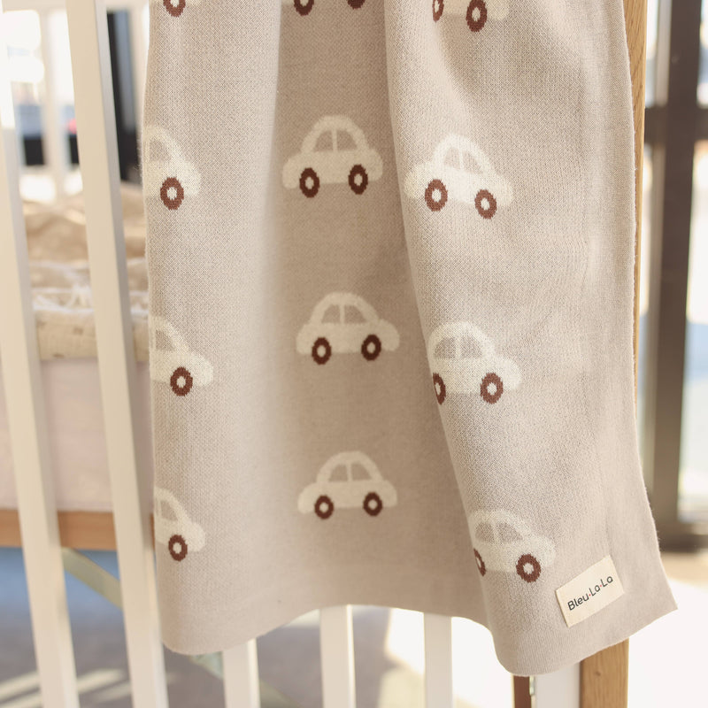blu la la cars knit cotton newborn blanket hanging from crib 
