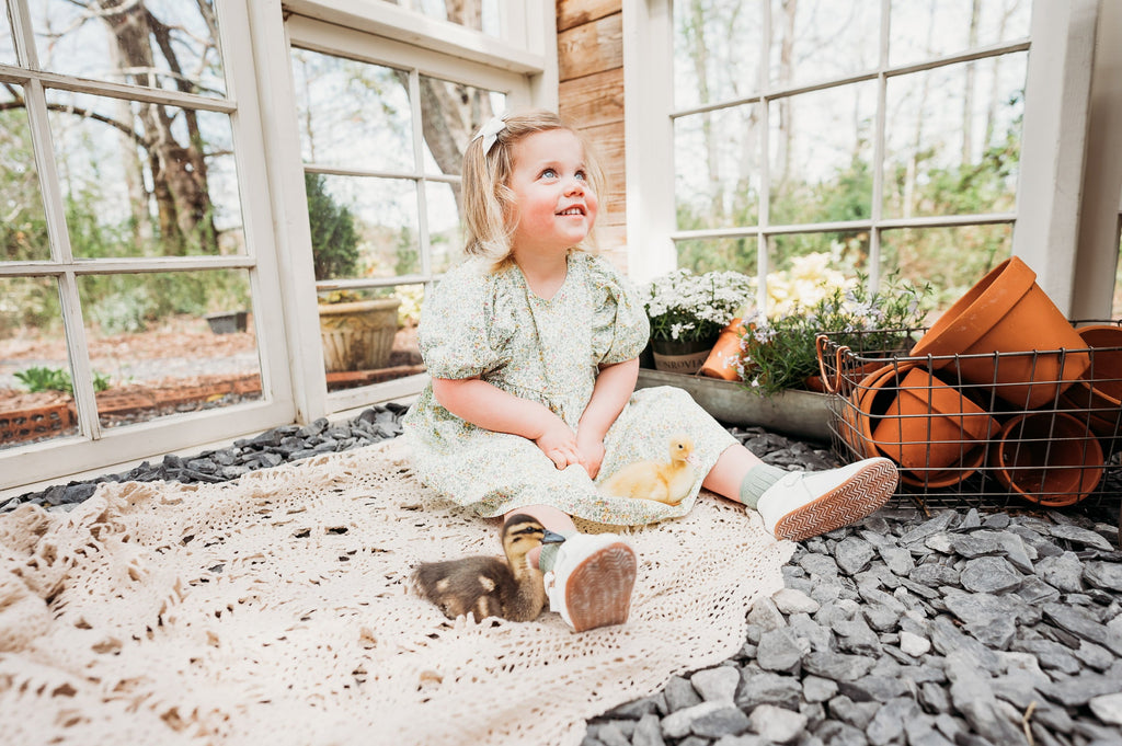 The anti-slip soles of the  Little Love Bug Co. white leather t-bar shoes