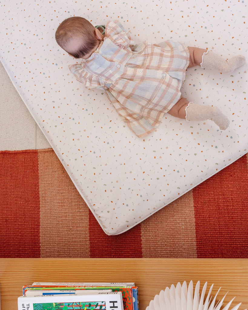 Baby rolling around on the Piccalio play mat.'