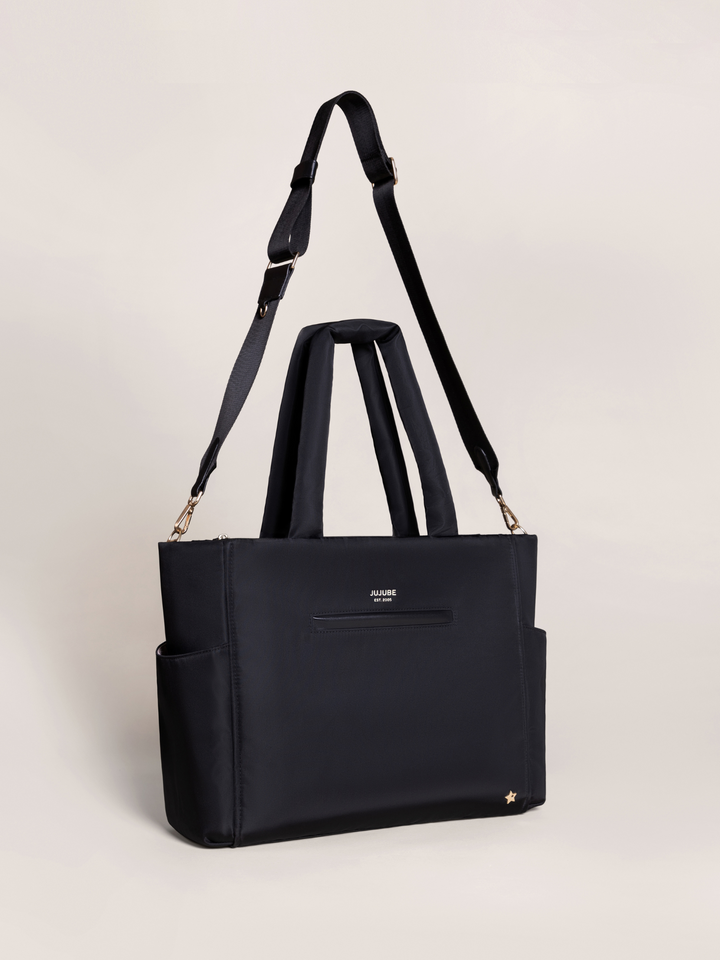 Cushioned changing pad and easy-access wipe pocket in JuJuBe Utility-Strap Tote in Black