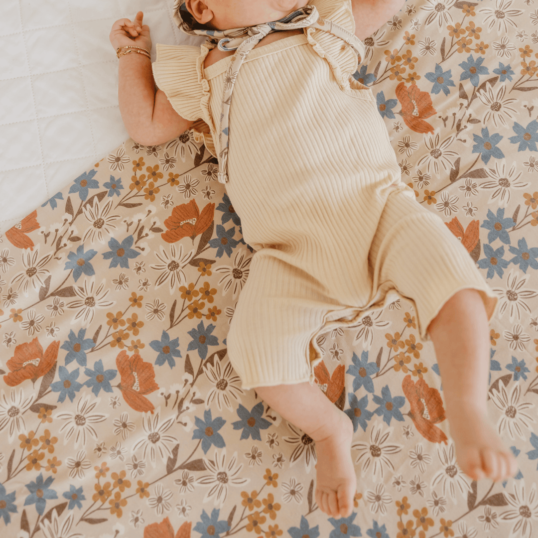 Newborn swaddled in Copper Pearl Eden knit receiving blanket