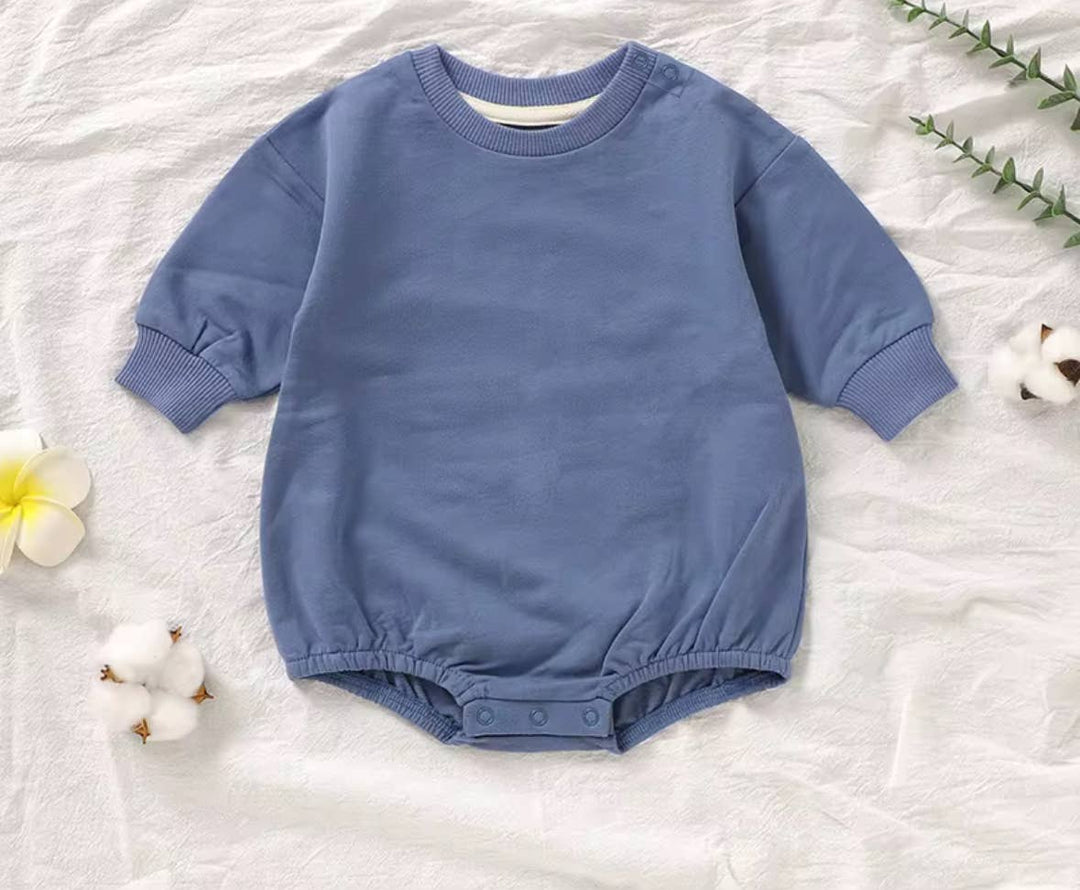 boho babe extra soft ocean blue baby bubble one piece romper on cotton background
