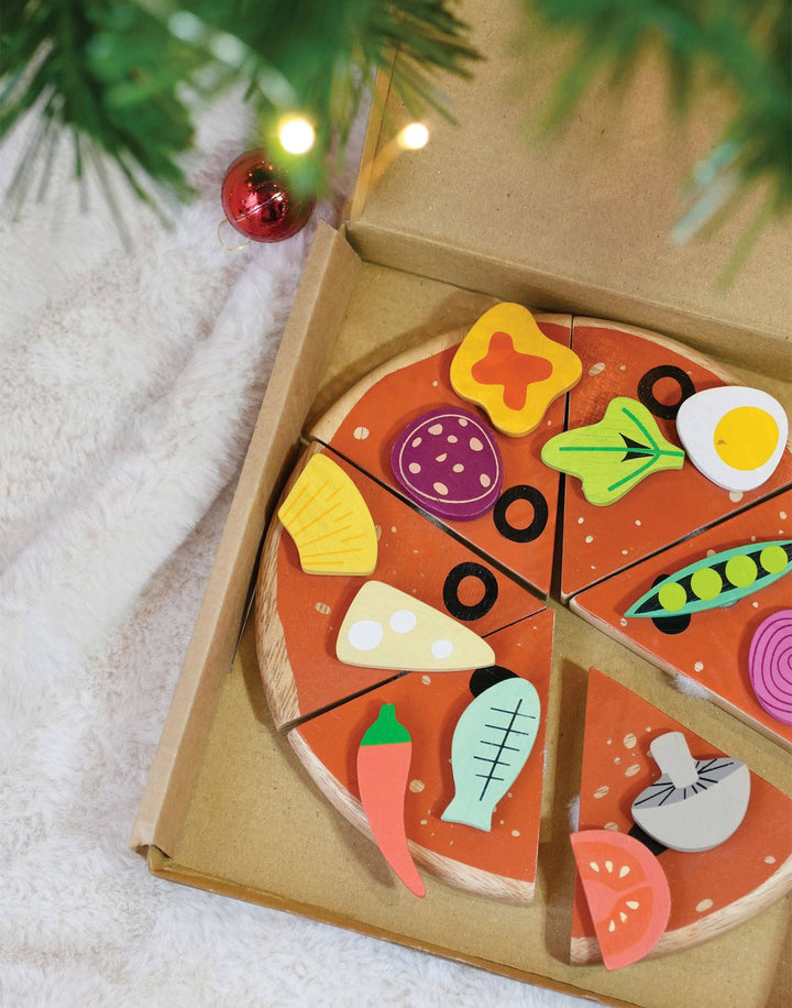Tender Leaf Toys Pizza Party displayed near string lights during a festive scene