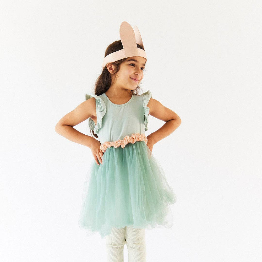 A child models the Cottontail Bunny Ears in a sage tulle dress, an Easter favorite from Sarah's Silks