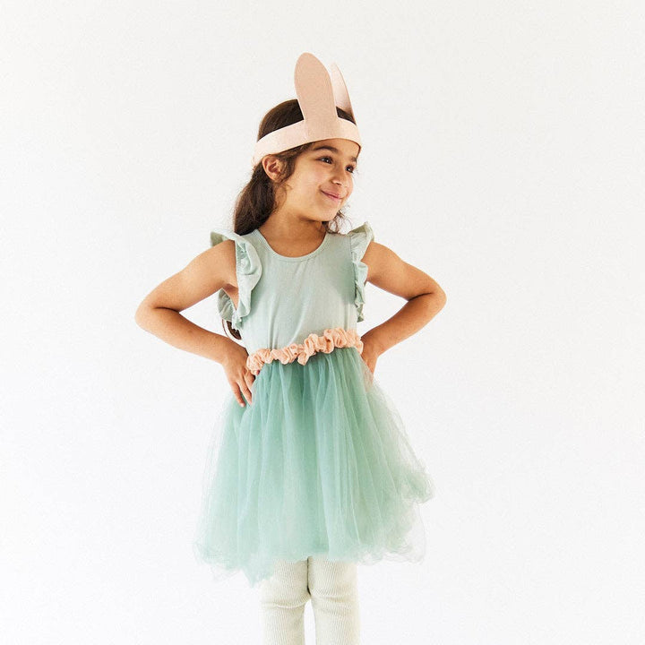 A child models the Cottontail Bunny Ears in a sage tulle dress, an Easter favorite from Sarah's Silks