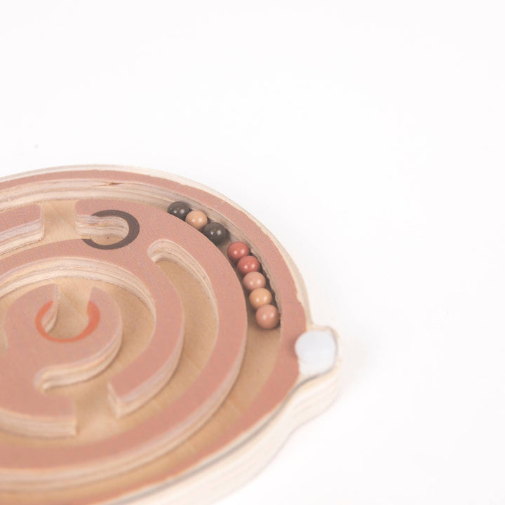 Zoomed in, the spiral groove on Egmont's Mini Magnetic Color Maze curves toward the center