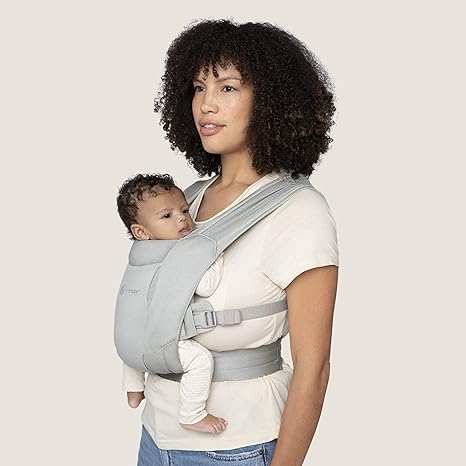 Keep baby snug with the Ergobaby Embrace Newborn Carrier in Soft Grey, an ergonomic baby chest carrier.