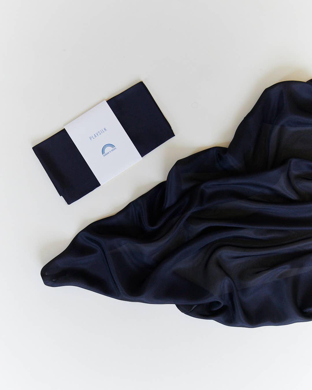 Navy silk scarf flat lay, Sarah's Silks Solid Color Playsilks, a well loved imaginative toy