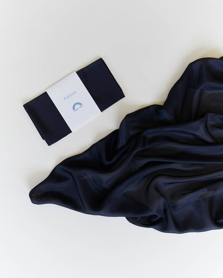 Navy silk scarf flat lay, Sarah's Silks Solid Color Playsilks, a well loved imaginative toy