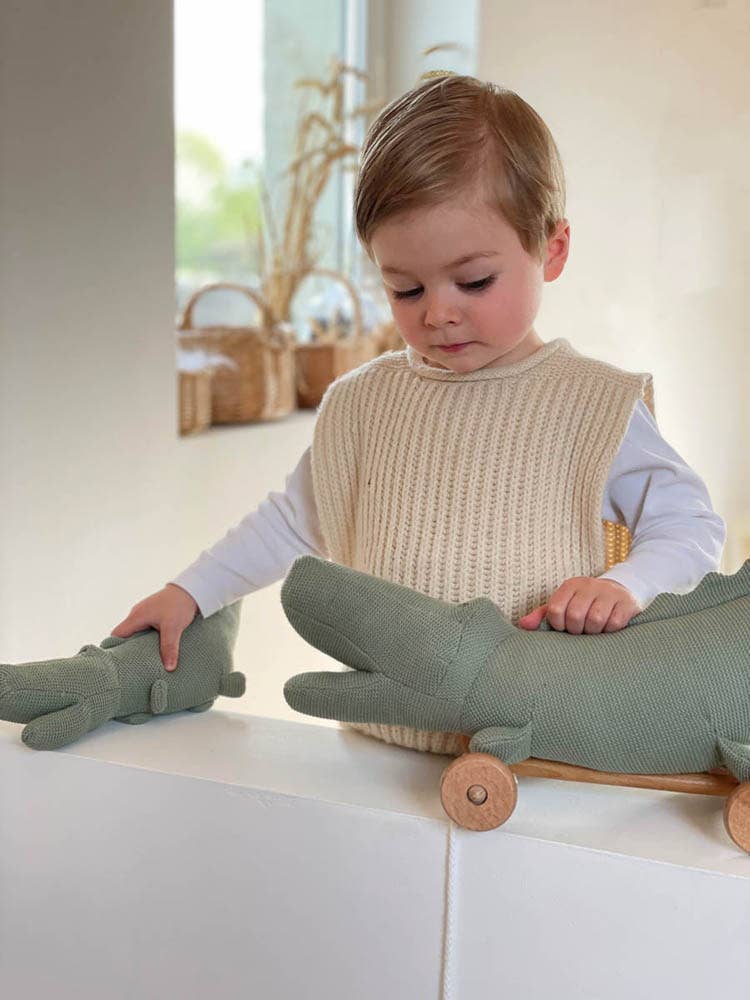 toddler playing with woven crocodile egmont push toy 
