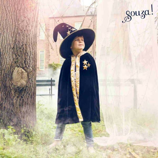 Child wearing a wizard costume and the Souza Wilfred Magician Hat Costume Accessory standing in a forest